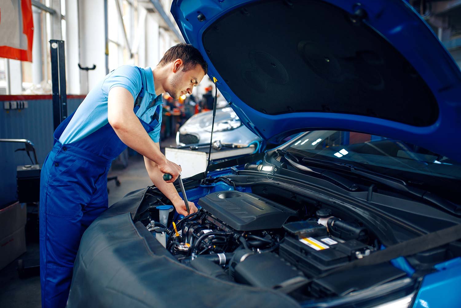 worker-in-uniform-checks-engine-car-service-small.jpg